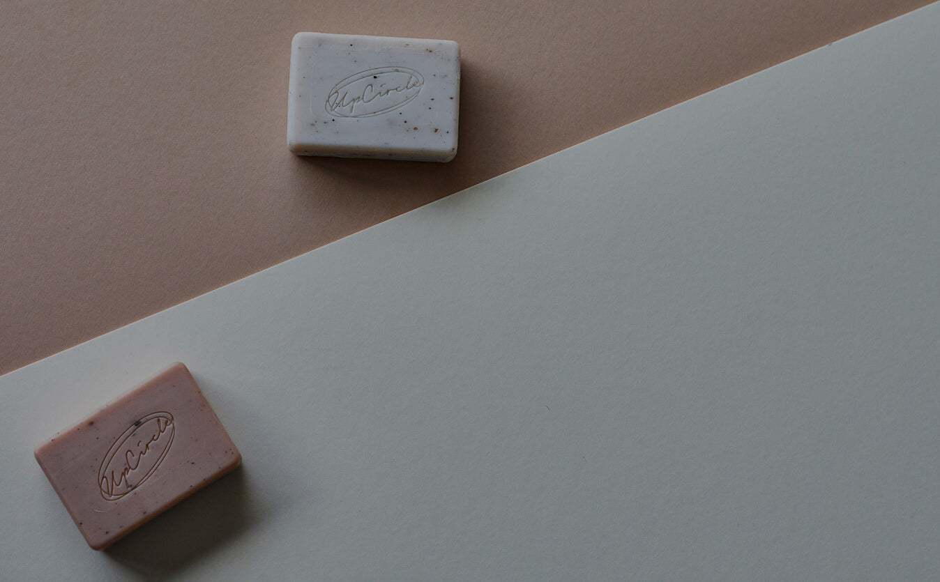 UpCircle cleansing and soap products on a dark background