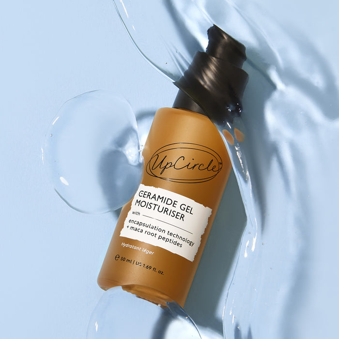 small product image-8,UpCircle Ceramide Gel Moisturiser bottle lying in a pool of the clear cooling gel